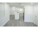 Spacious, open-concept living and kitchen area with recessed lighting and grey wood-look floors at 5510 12Th St, Zephyrhills, FL 33542