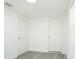 A well-lit room with two doors and a window, featuring gray wood-look flooring at 5510 12Th St, Zephyrhills, FL 33542