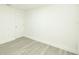 This room features wood-look flooring, white walls, and a door at 5510 12Th St, Zephyrhills, FL 33542