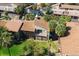 Aerial view of a townhouse with a screened lanai and scenic landscaping and lake views at 6324 Newtown Cir # 24B1, Tampa, FL 33615