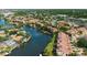 Aerial view of community on waterway with lush landscape, docks and boats at 6324 Newtown Cir # 24B1, Tampa, FL 33615