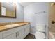 Bathroom features a large mirror, spacious vanity, and neutral color scheme at 6324 Newtown Cir # 24B1, Tampa, FL 33615
