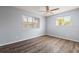 Bedroom with two windows providing natural light and beautiful wood-look floors at 6324 Newtown Cir # 24B1, Tampa, FL 33615