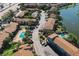 Aerial view of the community featuring lush landscaping, two community pools, and lake access at 6324 Newtown Cir # 24B1, Tampa, FL 33615