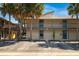 Condo complex featuring reserved parking spaces and tropical palm trees on a sunny day at 6324 Newtown Cir # 24B1, Tampa, FL 33615