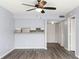 Cozy living room features ceiling fan, bar area, and view of the front entry at 6324 Newtown Cir # 24B1, Tampa, FL 33615