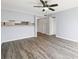 Open-concept living room features modern ceiling fan and attractive wood-look flooring at 6324 Newtown Cir # 24B1, Tampa, FL 33615