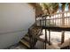Exterior staircase with wooden railing and tropical landscaping at 6324 Newtown Cir # 24B1, Tampa, FL 33615
