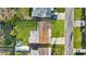 A top-down view of a home with a large, grassy yard and mature trees at 6334 Hyperion Dr, Port Richey, FL 34668