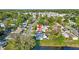 Aerial view showcasing a residential area with green spaces, ponds, and mature trees at 6334 Hyperion Dr, Port Richey, FL 34668