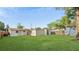 View of the spacious backyard featuring lush lawn, gazebo, and partial fencing at 6334 Hyperion Dr, Port Richey, FL 34668