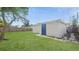 Exterior shot of a shed or addition in the backyard, surrounded by green lawn at 6334 Hyperion Dr, Port Richey, FL 34668