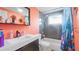 This bathroom features a dark vanity, unique color and shower curtain at 6334 Hyperion Dr, Port Richey, FL 34668