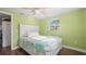 This bedroom has hard wood floors, a ceiling fan, and a nice window with a street view at 6334 Hyperion Dr, Port Richey, FL 34668