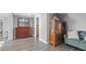 This bedroom features wood floors, a blue couch and a mahogany dresser and shelving unit at 6334 Hyperion Dr, Port Richey, FL 34668