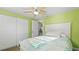 This bedroom offers an open closet, ceiling fan, and a nice window with a street view at 6334 Hyperion Dr, Port Richey, FL 34668