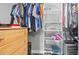 Inside this closet is a shelving unit and wooden drawers. There is ample hanging storage in this closet at 6334 Hyperion Dr, Port Richey, FL 34668