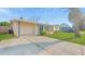 Charming single Gathering home featuring an attached garage and lush green lawn at 6334 Hyperion Dr, Port Richey, FL 34668