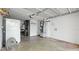 This garage is an open space, and includes a refrigerator, work bench, and access to the outside at 6334 Hyperion Dr, Port Richey, FL 34668