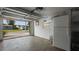 This garage features an open door, a refrigerator, and access to the outside at 6334 Hyperion Dr, Port Richey, FL 34668