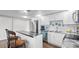 Well-lit kitchen featuring stainless steel appliances, and a convenient breakfast bar, ideal for casual dining at 6334 Hyperion Dr, Port Richey, FL 34668