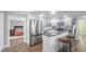 Modern kitchen with stainless steel appliances and a breakfast bar, flowing into the living space at 6334 Hyperion Dr, Port Richey, FL 34668