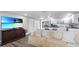 Open floor plan showcasing the living room with kitchen featuring modern appliances and island seating at 6334 Hyperion Dr, Port Richey, FL 34668