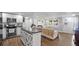 Inviting view of the open living space flowing into the kitchen with a breakfast bar, perfect for entertaining at 6334 Hyperion Dr, Port Richey, FL 34668