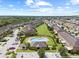 Wide aerial view displays the community featuring a sparkling pool, clubhouse, and beautiful landscaping at 6974 Holly Heath Dr, Riverview, FL 33578