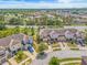 Aerial view of townhomes with well-maintained landscaping and ample parking, showcasing community living at 6974 Holly Heath Dr, Riverview, FL 33578