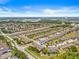 Residential area with townhomes and manicured landscaping near a lake and green spaces, close to services at 6974 Holly Heath Dr, Riverview, FL 33578