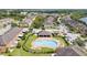 Wonderful aerial view showcasing the community pool, clubhouse, and neat landscaping in the neighborhood at 6974 Holly Heath Dr, Riverview, FL 33578