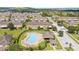 Attractive aerial view of the community pool, clubhouse, and well-maintained townhomes at 6974 Holly Heath Dr, Riverview, FL 33578
