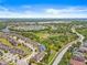 Gorgeous aerial view of the community featuring lush landscaping, lakes, nearby highways, and well-maintained homes at 6974 Holly Heath Dr, Riverview, FL 33578