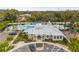 Bird's eye view of the community clubhouse, well-manicured landscaping, ample parking, and a resident pool at 6974 Holly Heath Dr, Riverview, FL 33578