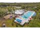 Stunning aerial view shows a community pool, a splash pad with a slide, a clubhouse, and a playground at 6974 Holly Heath Dr, Riverview, FL 33578
