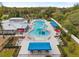 Aerial view of community pool with slides, lounge chairs, cabanas, and lush landscaping creating a resort-like feel at 6974 Holly Heath Dr, Riverview, FL 33578