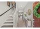 Welcoming entryway with staircase, stylish console table, and modern decor leading to living spaces at 6974 Holly Heath Dr, Riverview, FL 33578