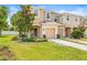 Inviting townhome showcases a manicured lawn, mature trees, and a double garage with stylish curb appeal at 6974 Holly Heath Dr, Riverview, FL 33578