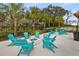 Inviting community fire pit area with Adirondack chairs, perfect for relaxation and social gatherings at 6974 Holly Heath Dr, Riverview, FL 33578