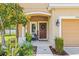 Inviting front porch with decorative plants, comfortable seating, and a welcoming atmosphere at 6974 Holly Heath Dr, Riverview, FL 33578