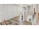 Hallway with hardwood floors leading to a staircase and several rooms at 6974 Holly Heath Dr, Riverview, FL 33578