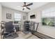 Home office with multiple monitors, treadmil and large windows for natural light at 6974 Holly Heath Dr, Riverview, FL 33578