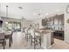 Open-concept kitchen with granite island, stainless appliances, and seamless flow to living area at 6974 Holly Heath Dr, Riverview, FL 33578