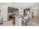 A kitchen with a central island, granite countertops, stainless steel appliances, and dark wood cabinets at 6974 Holly Heath Dr, Riverview, FL 33578