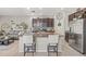 A kitchen with a central island, granite countertops, stainless steel appliances, and dark wood cabinets at 6974 Holly Heath Dr, Riverview, FL 33578