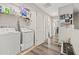 Laundry room with a washer, dryer, and organized shelving for convenience at 6974 Holly Heath Dr, Riverview, FL 33578