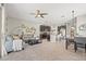 Open-concept living room featuring a modern ceiling fan, stylish decor, and seamless flow into the kitchen and dining area at 6974 Holly Heath Dr, Riverview, FL 33578