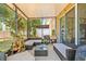 Well-furnished screened-in patio with cozy seating, perfect for outdoor enjoyment at 6974 Holly Heath Dr, Riverview, FL 33578