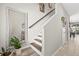 Bright staircase with modern railing, leading to upper level, adjacent to a stylishly decorated hallway at 6974 Holly Heath Dr, Riverview, FL 33578